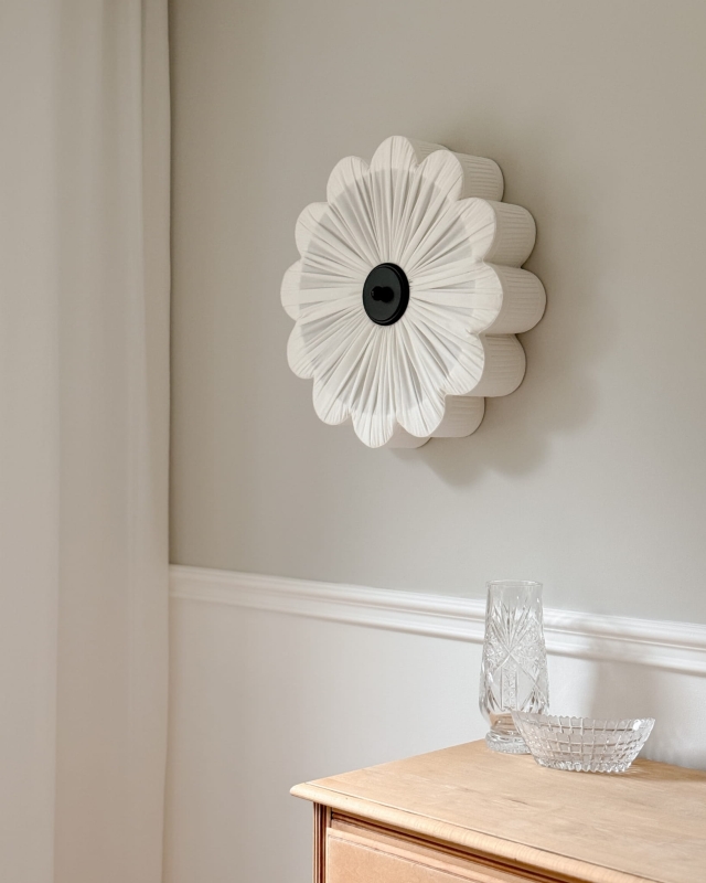 Biały kinkiet w kształcie kwiatu z czarnym dekorem PEONIA BLACK I śmietankowa biel w aranżacji na ścianie.