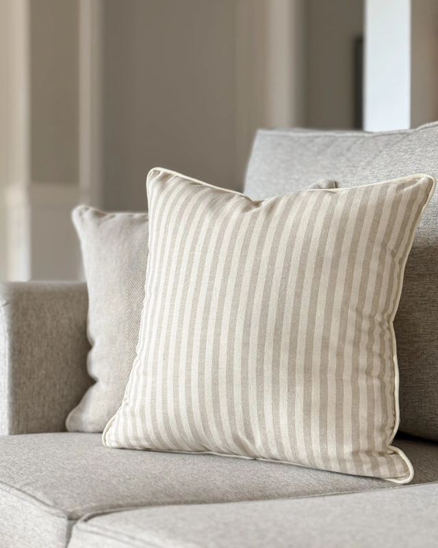 Kwadratowa poszewka w beżowo-kremowe paski SAND 45x45 cm - aranżacja na kanapie w salonie.